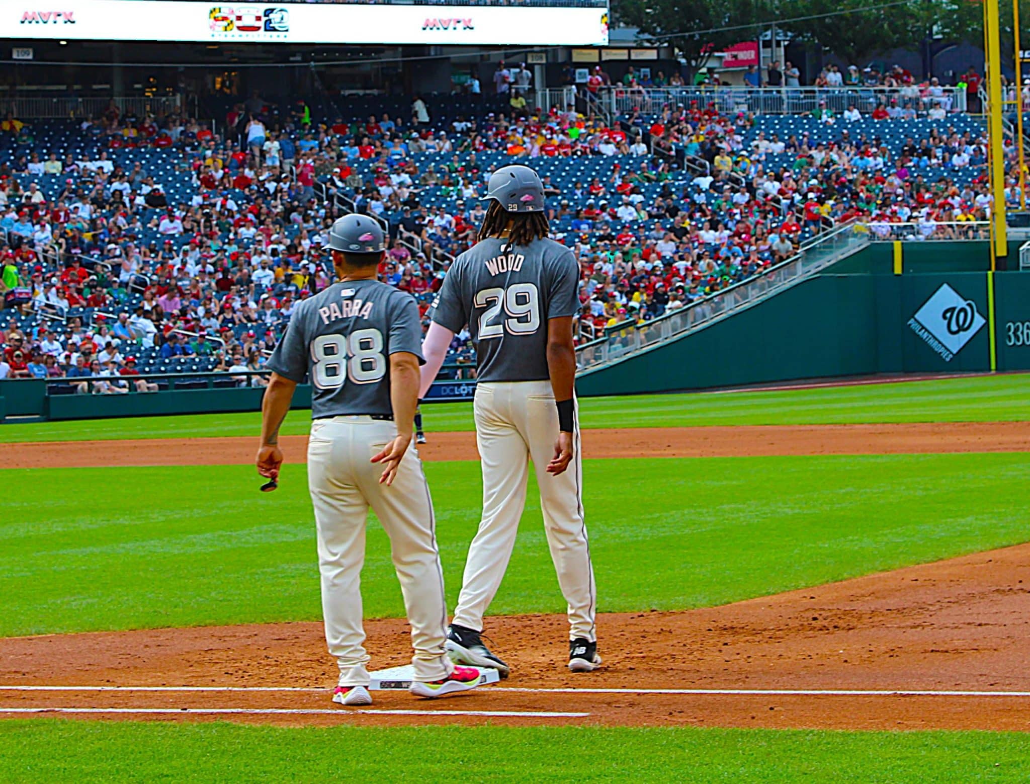 James Wood and first base coach Gerardo Parra